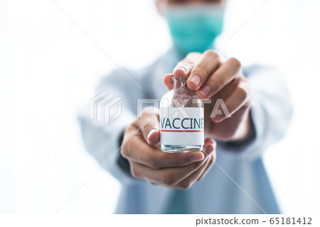A doctor or scientist in laboratory holding a A doctor or scientist in laboratory holding a 65181412