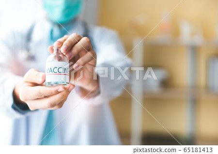 A doctor or scientist in laboratory holding a A doctor or scientist in laboratory holding a 65181413