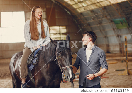 Cute loving couple with horse on ranch Cute loving couple with horse on ranch 65183569