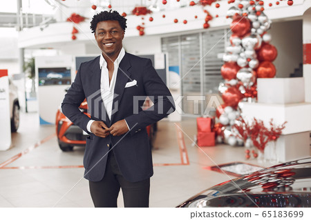 Handsome and elegant black man in a car salon Handsome and elegant black man in a car salon 65183699