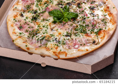 Fresh hot pizza with bacon, onions and greens 65184215