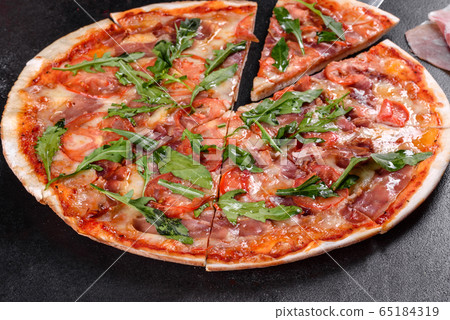 Fresh pizza baked in oven with arugula Fresh pizza baked in oven with arugula 65184319