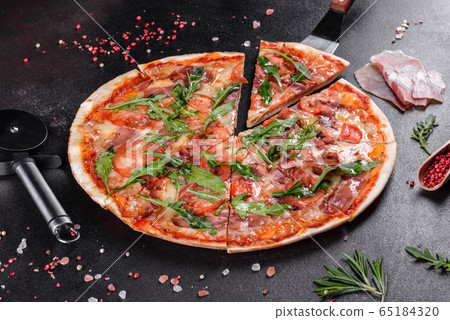 Fresh pizza baked in oven with arugula Fresh pizza baked in oven with arugula 65184320