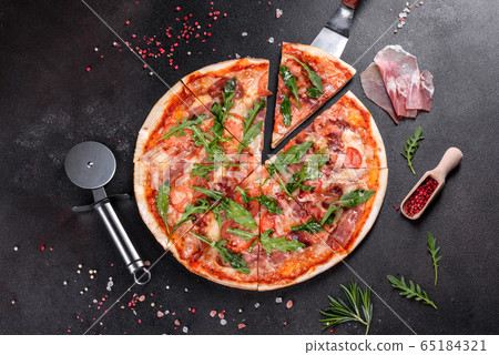 Fresh pizza baked in oven with arugula Fresh pizza baked in oven with arugula 65184321