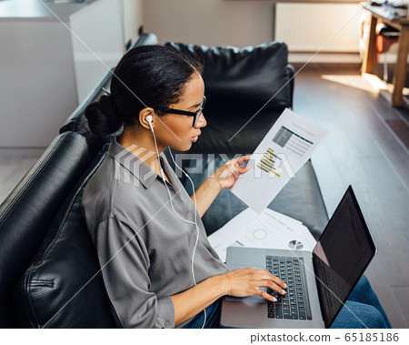 Young female entrepreneur working on laptop Young female entrepreneur working on laptop 65185186