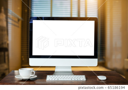 Workspace with computer Monitor, Keyboard, blank screen coffee cup smartphone, and tablet on a table or White Screen Isolated in bright office room interior. Workspace with computer Monitor, Keyboard, blank screen coffee cup smartphone, and tablet on a table or White Screen Isolated in bright office room interior. 65186194