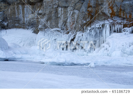 Rock cliff with ice stalactite in Lake Baikal, Russia 65186729