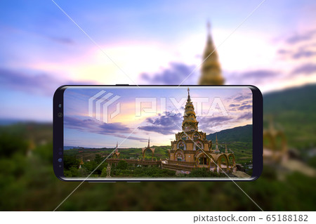 Beautiful golden pagoda in Wat Phra Thart Pha Sorn Kaew is taken a photo by mobile phone, that landmark in Khao Kho, Phetchabun province Thailand. 65188182