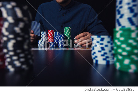 young man poker player hands holding cards and young man poker player hands holding cards and 65188653