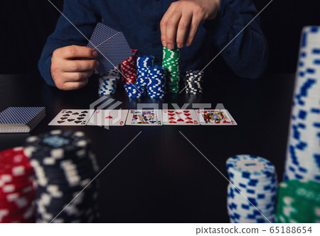 poker player hands holding cards and betting chips poker player hands holding cards and betting chips 65188654