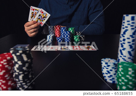 Close up of young man poker player hands holding Close up of young man poker player hands holding 65188655