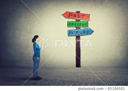 Side view of young woman standing in front of a Side view of young woman standing in front of a 65189381