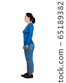 Full length side view of casual young woman 65189382
