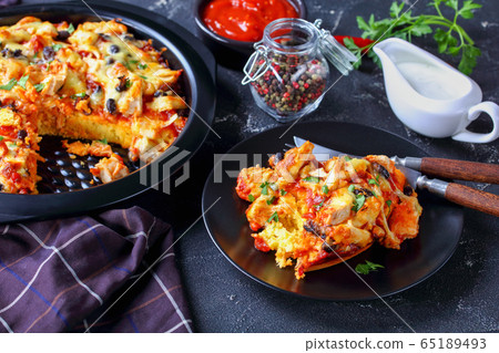 Tamale pie on a black baking dish, close-up Tamale pie on a black baking dish, close-up 65189493