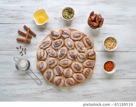 Eid Dates sweets on a wooden table, top view. Eid Dates sweets on a wooden table, top view. 65189519