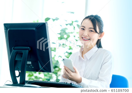 Office female smartphone computer desk work Office female smartphone computer desk work 65189700