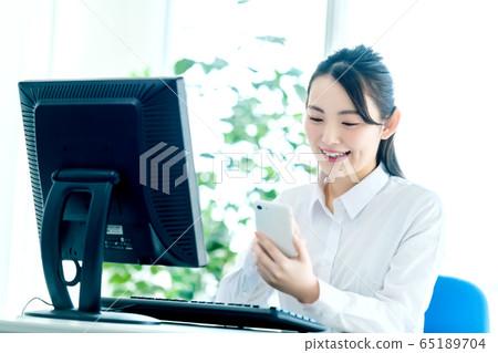 Office female smartphone computer desk work 65189704