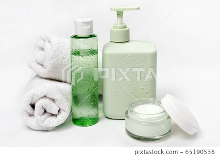 Cosmetic containers, blank label package for branding mock-up. Moisturizing cream, liquid soap or shampoo, tonic, face and body skin care. Natural green organic beauty product. 65190538