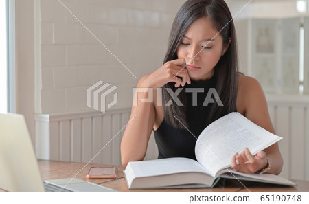 Young women are reading books for entrance Young women are reading books for entrance 65190748