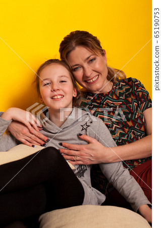 beautiful girl and wjman lies on a black sofa in homemade clothes with pillows beautiful girl and wjman lies on a black sofa in homemade clothes with pillows 65190753