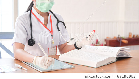 The doctor is recording the results of the blood The doctor is recording the results of the blood 65190992