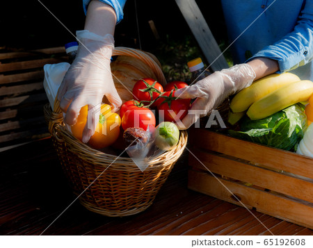 Woman in gloves on packages food package for the poor. 65192608
