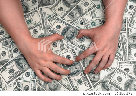 Hands on the background of American dollars Hands on the background of American dollars 65193172