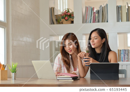 Portrait of Two young women searching for 65193445