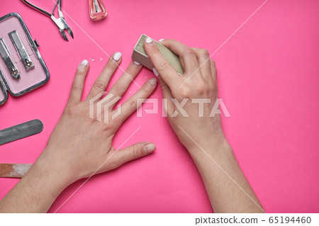 Overgrown nails with an old cracked gel polish. Self-removal of old gel polish from nails with a nail file. Overgrown nails with an old cracked gel polish. Self-removal of old gel polish from nails with a nail file. 65194460
