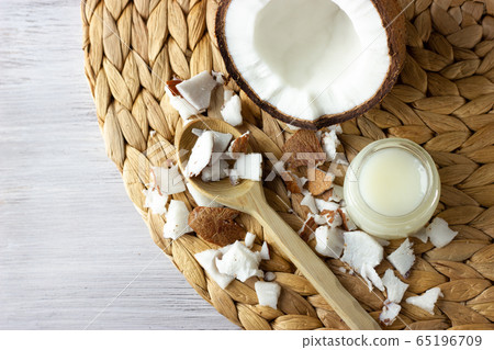 Coconut oil and fresh coconuts on the wooden table Coconut oil and fresh coconuts on the wooden table 65196709