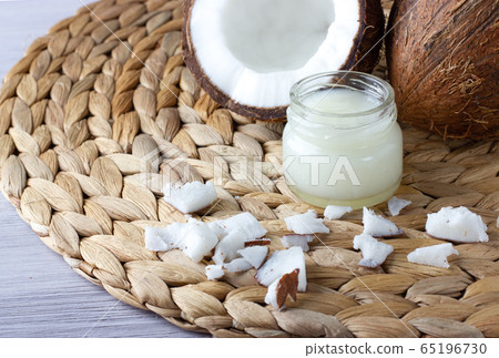 Coconut oil and fresh coconuts on the table Coconut oil and fresh coconuts on the table 65196730