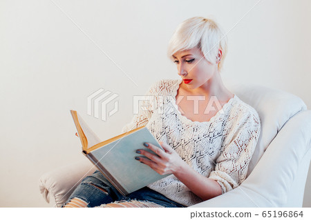 beautiful woman with short hair reading a book beautiful woman with short hair reading a book 65196864