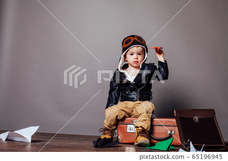 little boy pilot plays in the paper plane 65196945