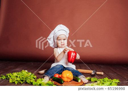 boy chef prepares carrots, pepper, Tomato Cucumber boy chef prepares carrots, pepper, Tomato Cucumber 65196998