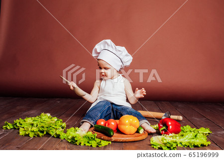 the boy chef with a wooden spoon, carrots, peppers, tomatoes, lettuce, cucumber the boy chef with a wooden spoon, carrots, peppers, tomatoes, lettuce, cucumber 65196999