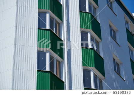 facade of a new multistory building with white and 65198383