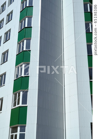 facade of a new multistory building with white and 65198386
