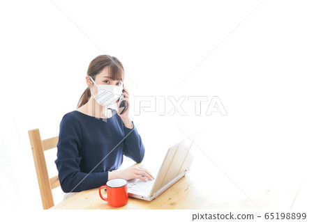 Young business woman wearing a mask and doing remote work 65198899
