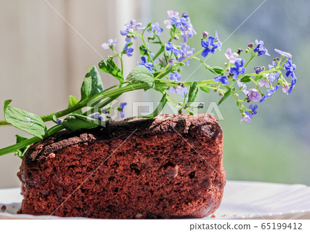 Homemade cakes and blue flowers 65199412