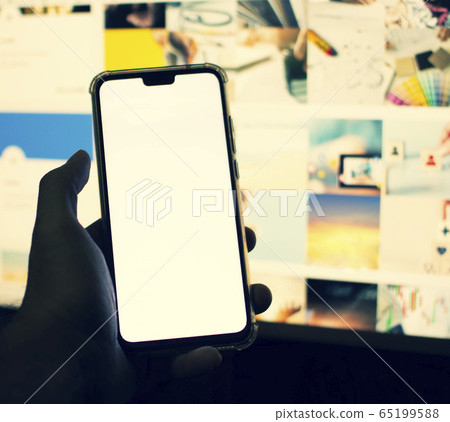 Smartphone with a blank white screen in hand. Smartphone with a blank white screen in hand. 65199588