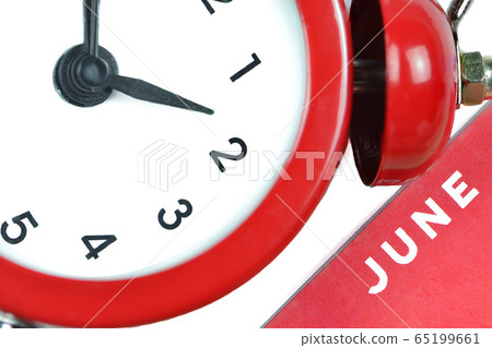 Part of a big red alarm clock with the name of the month of June 65199661