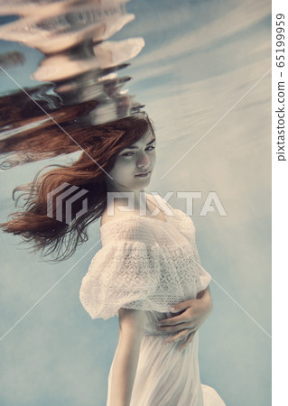 Portrait of a girl in a white dress underwater 65199959