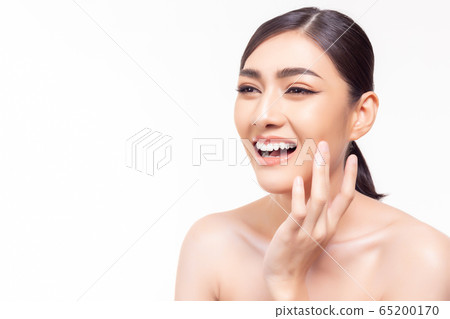 Beauty skin care. Asian woman get beautiful face skin, nice skin with happy. Attractive beautiful young girl look at copy space, smiley face and satisfied smooth face by touching her face. skin care Beauty skin care. Asian woman get beautiful face skin, nice skin with happy. Attractive beautiful young girl look at copy space, smiley face and satisfied smooth face by touching her face. skin care 65200170