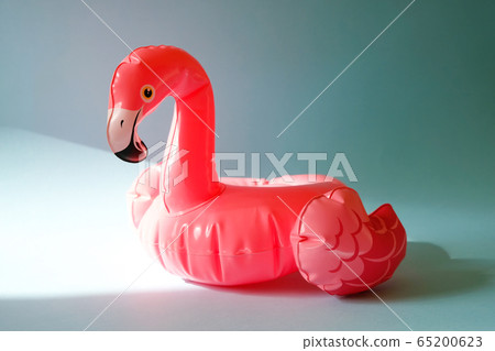 Inflatable pink flamingos on an blue background. Inflatable pink flamingos on an blue background. 65200623