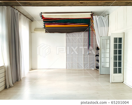 white photo studio with backgrounds accessories of a professional photographer 65201004