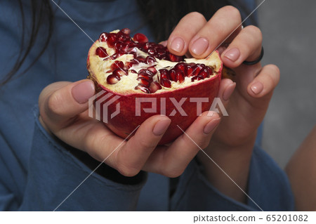 Half of the broken grenade in a woman's hands. 65201082