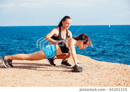 woman goes in for Sports Fitness on the beach woman goes in for Sports Fitness on the beach 65201319