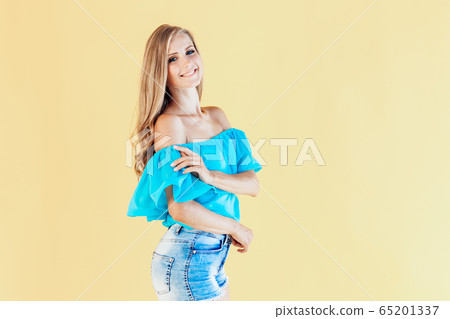 blonde girl in a blue dress, on a yellow background blonde girl in a blue dress, on a yellow background 65201337