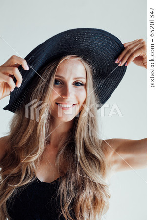blonde girl with blue eyes a hat with a brim on a white background 65201342