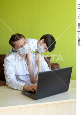 Father working from home with son during the coronavirus quarantine. Home schooling and freelance job concept. 65202144